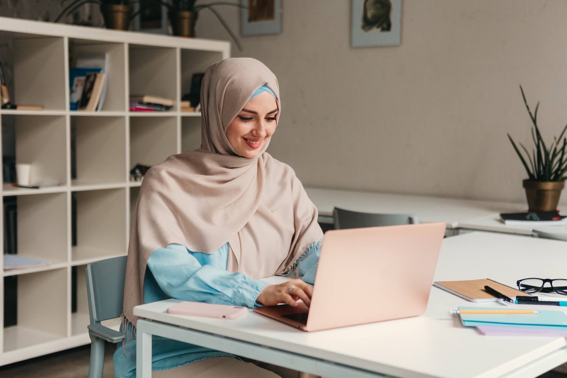 young-pretty-modern-muslim-woman-hijab-working-laptop-office-room-education-online(1)